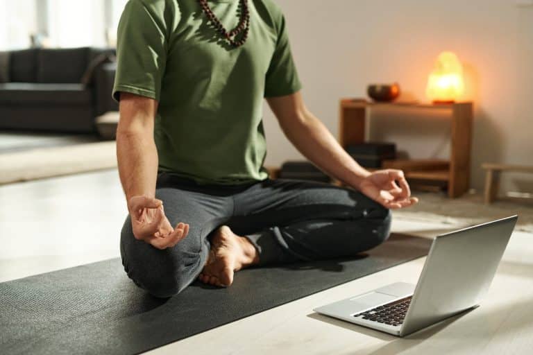 Man using laptop during his meditation